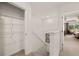 Hallway with carpeted stairs, storage closet, and a bedroom view at 1315 Aura Ln, Lawrenceville, GA 30045