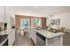 Open-concept kitchen featuring granite countertops, stainless steel appliances, and eat-in island at 1315 Aura Ln, Lawrenceville, GA 30045