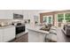 Contemporary kitchen featuring stainless steel appliances, granite countertops, and a breakfast bar at 1315 Aura Ln, Lawrenceville, GA 30045