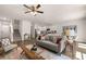 Open-concept living room boasts stylish furnishings, wood flooring, and abundant natural light at 1315 Aura Ln, Lawrenceville, GA 30045