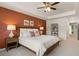 Relaxing primary bedroom with plush carpet, a ceiling fan, and an ensuite bathroom at 1315 Aura Ln, Lawrenceville, GA 30045