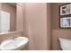 Stylish powder room featuring modern fixtures and a decorative mirror at 1315 Aura Ln, Lawrenceville, GA 30045