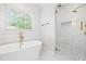 Bright bathroom featuring a soaking tub, a walk-in shower, and modern fixtures at 313 Sisson Ne Ave, Atlanta, GA 30317