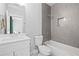 Bathroom with white vanity, tiled walls, and bathtub at 313 Sisson Ne Ave, Atlanta, GA 30317