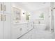 Elegant bathroom featuring double vanities, a soaking tub, a walk-in shower and modern fixtures at 313 Sisson Ne Ave, Atlanta, GA 30317