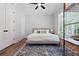 Serene bedroom with a modern accent wall, hardwood floors, and natural light at 313 Sisson Ne Ave, Atlanta, GA 30317