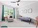 Bright bedroom with a cozy chair, a stylish bed and a ceiling fan at 313 Sisson Ne Ave, Atlanta, GA 30317