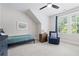 Comfortable bedroom with blue accent chair and plenty of natural light at 313 Sisson Ne Ave, Atlanta, GA 30317