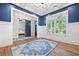 Sophisticated dining room featuring wainscoting, a blue accent wall, and a stylish doorway to a bedroom at 313 Sisson Ne Ave, Atlanta, GA 30317