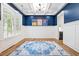 Elegant dining room with wainscoting, blue accent wall, coffered ceiling, and stylish decor at 313 Sisson Ne Ave, Atlanta, GA 30317