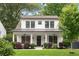 Charming two-story home with a well-manicured lawn and inviting front porch at 313 Sisson Ne Ave, Atlanta, GA 30317