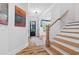 Bright foyer featuring hardwood floors, staircase, and a view into the living spaces at 313 Sisson Ne Ave, Atlanta, GA 30317