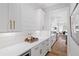 Bright kitchen featuring white cabinetry, subway tile backsplash, and a serving area at 313 Sisson Ne Ave, Atlanta, GA 30317