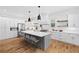 Spacious kitchen with stainless steel appliances, a large island, and ample cabinet space at 313 Sisson Ne Ave, Atlanta, GA 30317