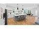 Well-lit kitchen offering a seamless flow into the dining area, featuring a large island and stainless appliances at 313 Sisson Ne Ave, Atlanta, GA 30317