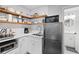 Modern kitchenette features white cabinets, subway tile backsplash, floating shelves, and stainless steel appliances at 313 Sisson Ne Ave, Atlanta, GA 30317