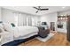 Open-concept living area featuring hardwood floors, a ceiling fan, and a cozy kitchenette with shelving at 313 Sisson Ne Ave, Atlanta, GA 30317