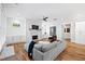 Bright and airy living room with a fireplace, shiplap accent wall, and hardwood floors at 313 Sisson Ne Ave, Atlanta, GA 30317