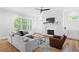 Cozy living room with a fireplace, shiplap wall, comfortable seating, and hardwood floors at 313 Sisson Ne Ave, Atlanta, GA 30317