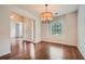Dining room with hardwood flooring, chandelier lighting, and a view of the front door and entry area at 3404 Bodiford Path Path, Powder Springs, GA 30127