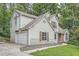 Traditional two-story home with a garage, siding, shutters, and a mature tree-filled landscaped lot at 3404 Bodiford Path Path, Powder Springs, GA 30127