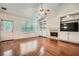 Bright living room with hardwood floors, fireplace, built-in shelving, a ceiling fan, and natural light at 3404 Bodiford Path Path, Powder Springs, GA 30127