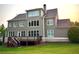View of the backyard featuring a multi-level deck, large windows, and a manicured lawn at 4530 Westgate Dr, Cumming, GA 30040