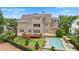 Stunning backyard features a refreshing pool with lounge chairs, a spacious deck, and mature trees at 4530 Westgate Dr, Cumming, GA 30040