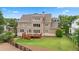 Expansive backyard with a well-maintained lawn, deck, and mature trees, perfect for outdoor activities at 4530 Westgate Dr, Cumming, GA 30040