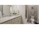 Bathroom with granite counters, white cabinets, and neutral walls at 4530 Westgate Dr, Cumming, GA 30040