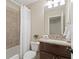 Cozy bathroom with white shower curtain and wood cabinet at 4530 Westgate Dr, Cumming, GA 30040