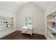 Bedroom nook featuring hardwood floors, a shuttered window, and built-in bookcases at 4530 Westgate Dr, Cumming, GA 30040