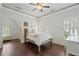 Bright bedroom featuring a bed with white linens, dark hardwood floors and shuttered windows at 4530 Westgate Dr, Cumming, GA 30040