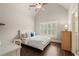 Bedroom with vaulted ceilings, hardwood floors, plantation shutters and a comfortable bed at 4530 Westgate Dr, Cumming, GA 30040