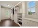 Walk-in closet with custom shelving, storage, and hardwood floors at 4530 Westgate Dr, Cumming, GA 30040