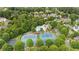 Aerial view of community amenities including a pool, tennis courts, and mature trees offering a vibrant lifestyle at 4530 Westgate Dr, Cumming, GA 30040