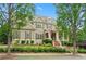 Charming two-story home framed by mature trees and lush greenery at 4530 Westgate Dr, Cumming, GA 30040