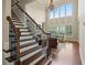 Grand foyer featuring staircase, chandelier, and large windows at 4530 Westgate Dr, Cumming, GA 30040