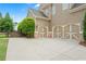Spacious three-car garage with carriage-style doors and a large driveway for ample parking at 4530 Westgate Dr, Cumming, GA 30040
