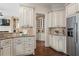 Kitchen featuring custom cabinets, granite countertops, stainless steel refrigerator, and adjoining butler's pantry at 4530 Westgate Dr, Cumming, GA 30040