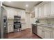 Kitchen features stainless steel appliances and custom cabinetry at 4530 Westgate Dr, Cumming, GA 30040