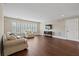 Living room with hardwood floors, neutral walls, plantation shutters and comfortable furniture at 4530 Westgate Dr, Cumming, GA 30040