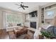 Bright living room with a fireplace, built-in shelves, and comfortable seating at 4530 Westgate Dr, Cumming, GA 30040