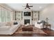Cozy living room with fireplace, built-in shelving, and elegant furniture at 4530 Westgate Dr, Cumming, GA 30040