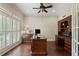 Well-lit office with hardwood floors, shutters, and custom-built desk, and storage cabinets at 4530 Westgate Dr, Cumming, GA 30040