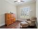 Cozy sitting room with a chair, ottoman, and a wooden storage cabinet at 4530 Westgate Dr, Cumming, GA 30040