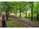 Picturesque gravel path lined with trees and a rustic fence, perfect for a peaceful walk in nature at 4530 Westgate Dr, Cumming, GA 30040