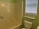 Bathtub and toilet situated by a window in a cheerful bathroom at 109 Ivy Crest Dr, Dallas, GA 30157
