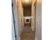 Hallway with gray walls, white trim, and hardwood floors leading to a fireplace at 109 Ivy Crest Dr, Dallas, GA 30157