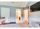 Bedroom with blue walls with an en suite bathroom for convenient access at 3746 Okefenokee Rdg, Loganville, GA 30052